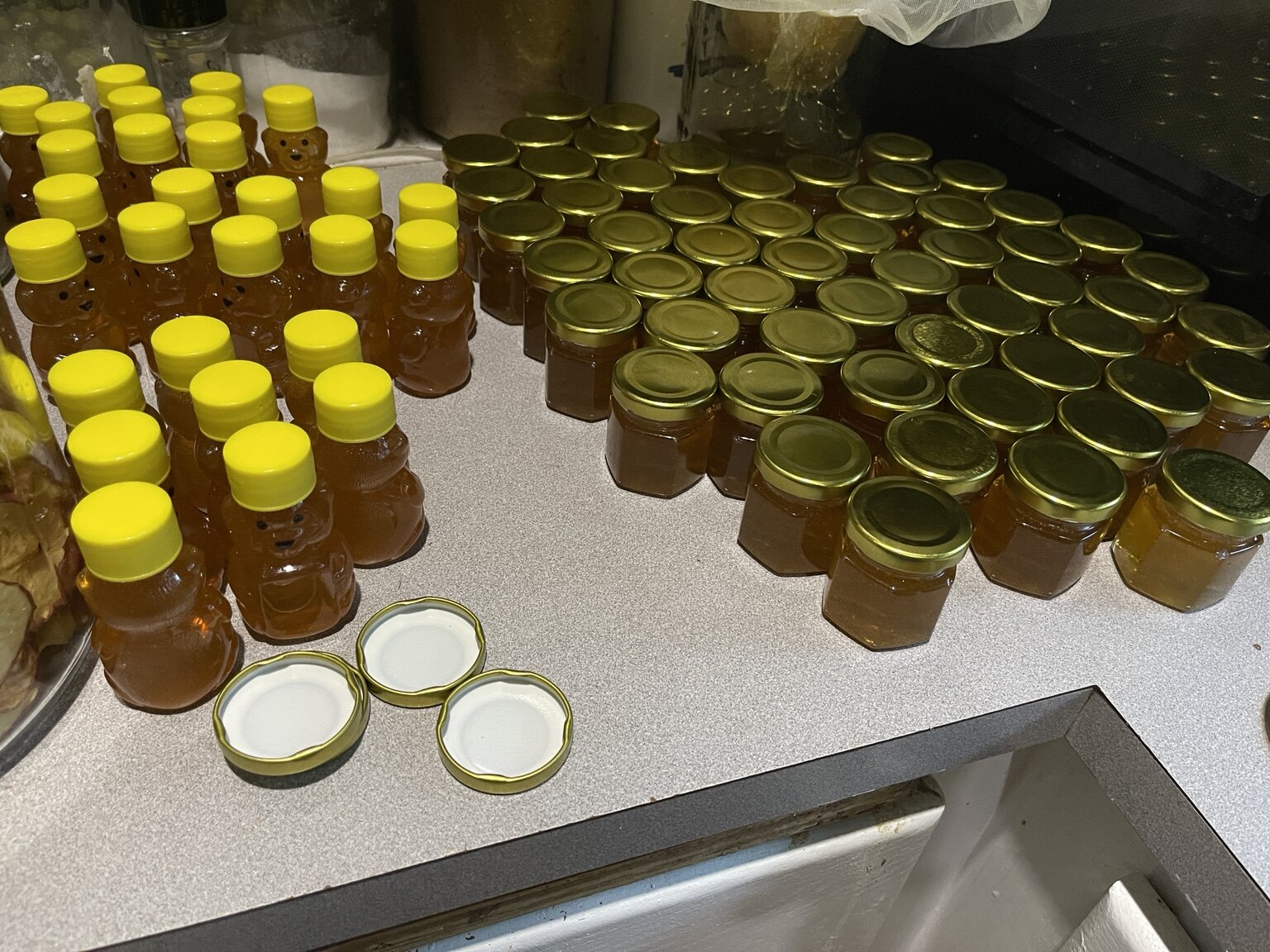 Freshly bottled honey in jars and bear bottles